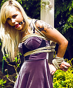 Blond roped to a pole and ball-gagged